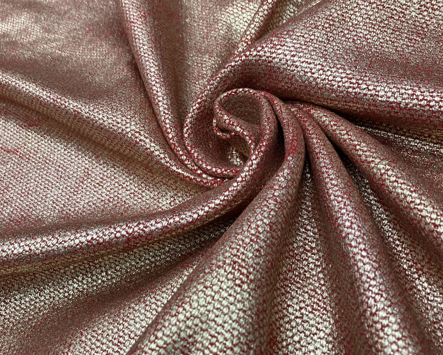 Close-up of metallic pink fabric with a slight sheen.