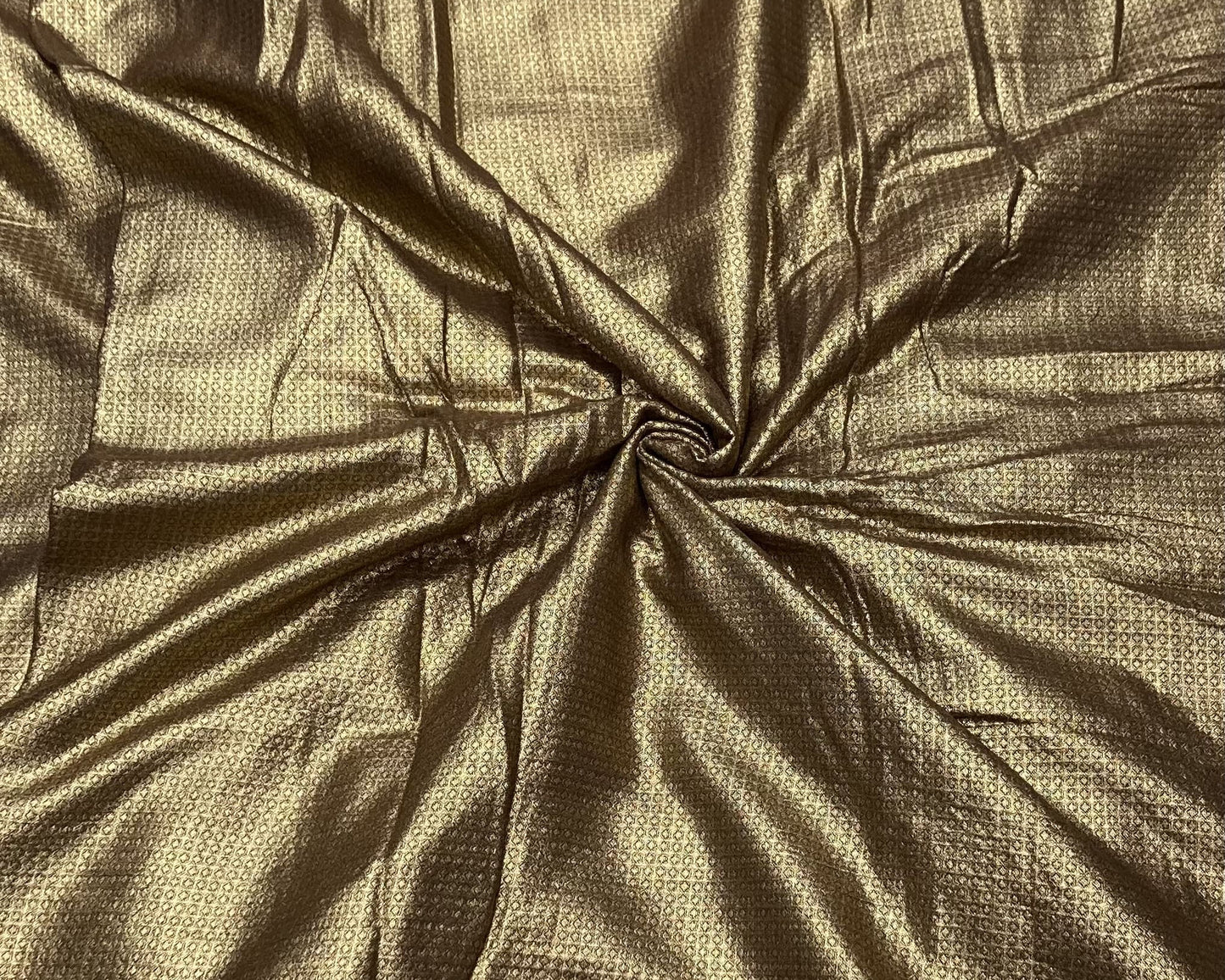 Close-up of gold fabric with a textured pattern