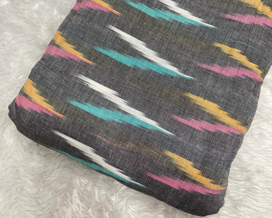 Folded fabric with colorful geometric pattern on a textured surface
