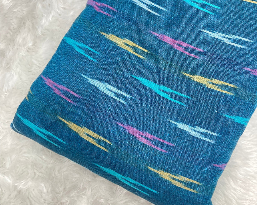 Blue fabric with colorful abstract patterns on a white background