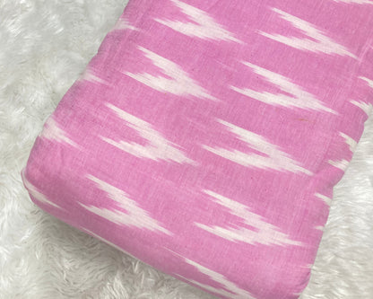 pink fabric with white pattern on a white fluffy background