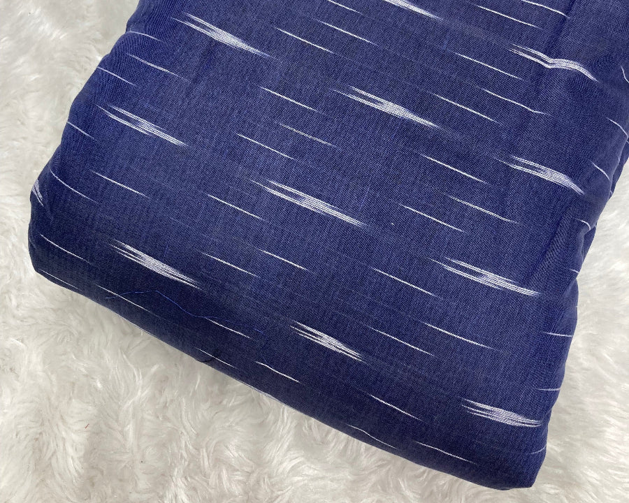 Blue fabric with white patterns on a textured white background